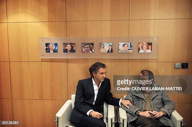 French best-selling authors Michel Houellebecq and Bernard-Henri Levy chat, on October 5 after being interviewed on the France 2 state TV news set by...