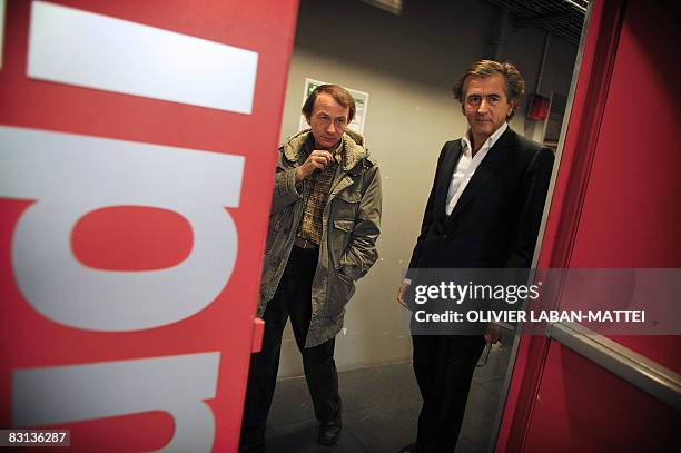 French best-selling authors Michel Houellebecq and Bernard-Henri Levy leave, on October 5 after being interviewed on the France 2 state TV news set...