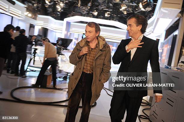 French best-selling authors Michel Houellebecq and Bernard-Henri Levy leave, on October 5 after being interviewed on the France 2 state TV news set...