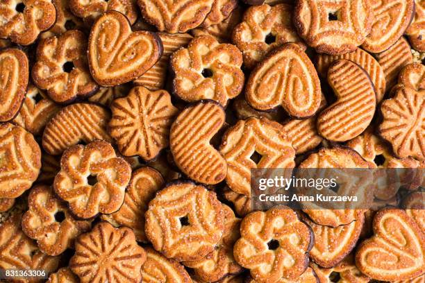 food background with cookies with sugar and dark chocolate glaze, top view - candy factory stockfoto's en -beelden