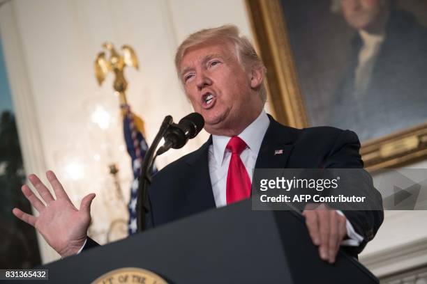President Donald Trump makes a statement in the Diplomatic Room at the White House in Washington, DC, on August 14, 2017. US President Donald Trump...