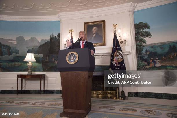 President Donald Trump makes a statement in the Diplomatic Room at the White House in Washington, DC, on August 14, 2017. US President Donald Trump...