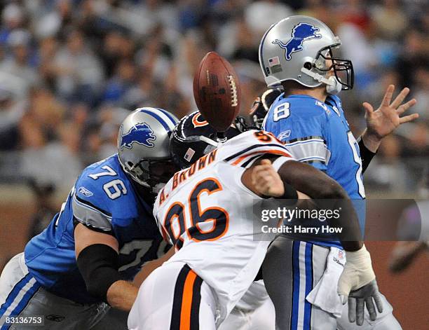 Alex Brown of the Chicago Bears causes a fumble on a sack of Jon Kitna of the Detroit Lions while defended by Jeff Backus during the first quarter at...
