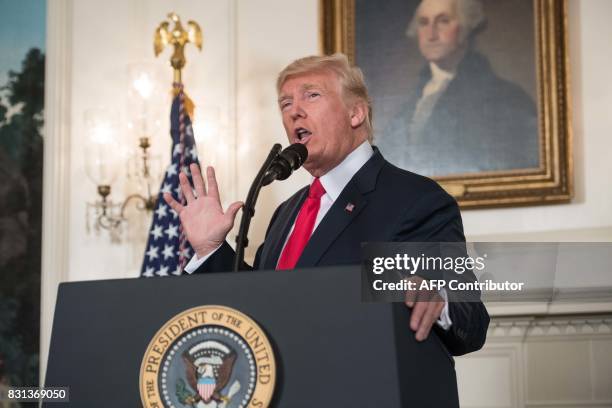 President Donald Trump makes a statement in the Diplomatic Room at the White House in Washington, DC, on August 14, 2017. US President Donald Trump...