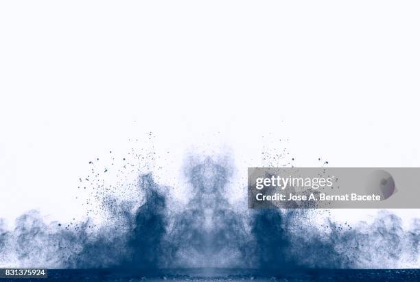 explosion of a cloud of powder of particles of colors gray and blue and a white background - powder blue imagens e fotografias de stock