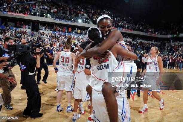 Olayinka Sanni jumps on Kara Braxton of the Detroit Shock after they win against the San Antonio Silver Stars in Game Three of the WNBA Finals to...