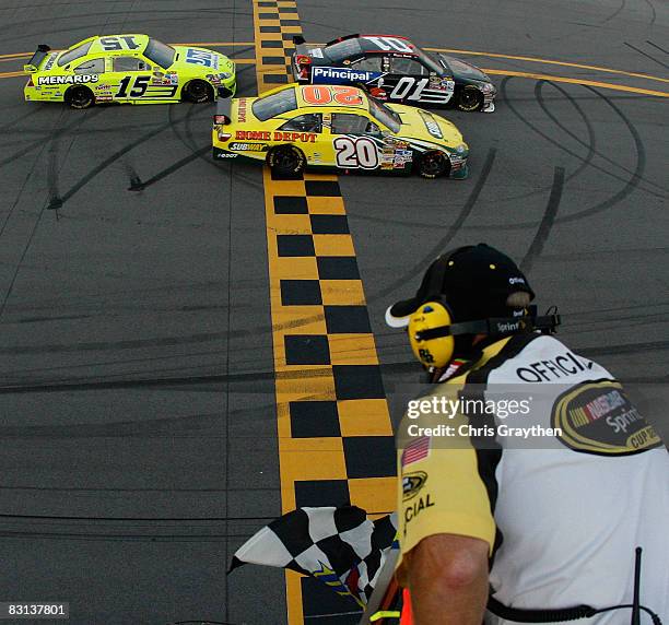 Regan Smith, driver of the DEI/The Principal Financial Group Chevrolet crosses the finishline with Tony Stewart, driver of the Subway/Home Depot...