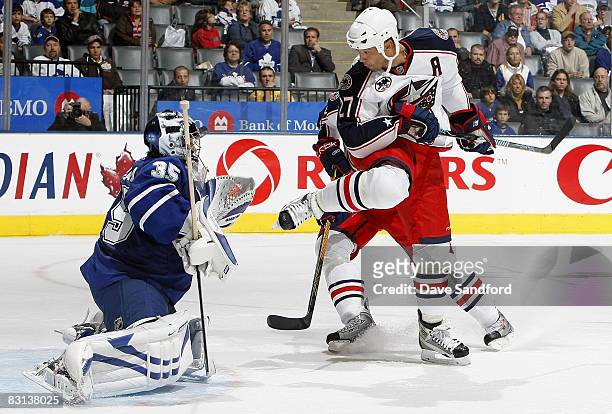 Manny Malhotra of the Columbus Blue Jackets screen's Vesa Toskala of the Toronto Maple Leafs as the puck hits his helmet during their pre season NHL...