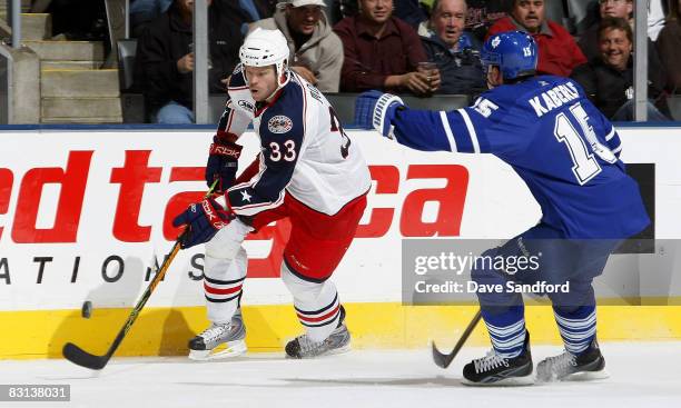 Frederik Modin of the Columbus Blue Jackets carries the puck pas Alex Steen of the Toronto Maple Leafs during their pre season NHL game at the Air...