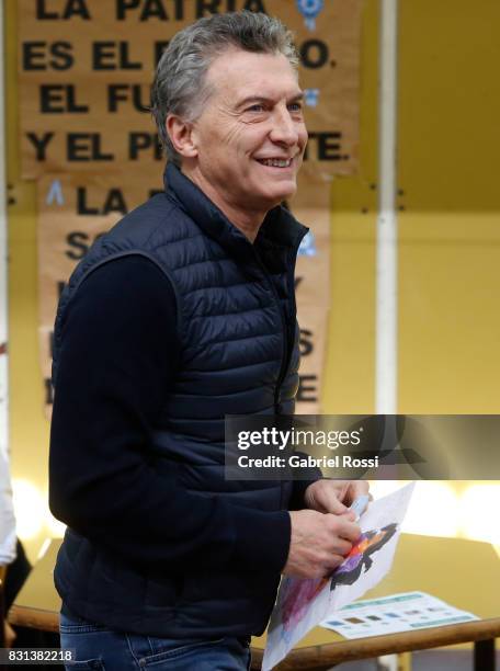 President of Argentina Mauricio Macri smiles during the midterm primary elections at Wencesleao Posse Nª16 school on August 13, 2017 in Buenos Aires,...