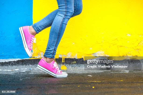 woman in pink sneakers - blue trousers stock pictures, royalty-free photos & images