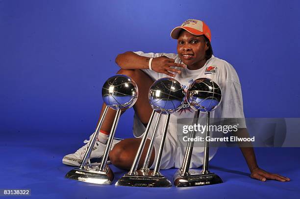 Elaine Powell of the Detroit Shock poses for a portrait with the trophy after winning Game Three of the WNBA Finals against the San Antonio Silver...