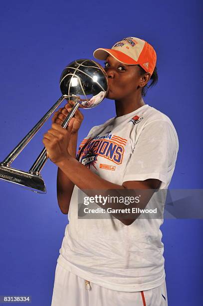 Kara Braxtron of the Detroit Shock poses for a portrait with the trophy after winning Game Three of the WNBA Finals against the San Antonio Silver...