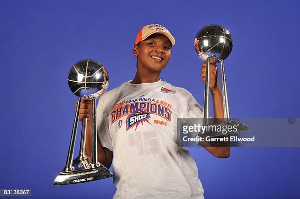 Kara Braxton of the Detroit Shock poses for a portrait with the trophy after winning Game Three of the WNBA Finals against the San Antonio Silver...