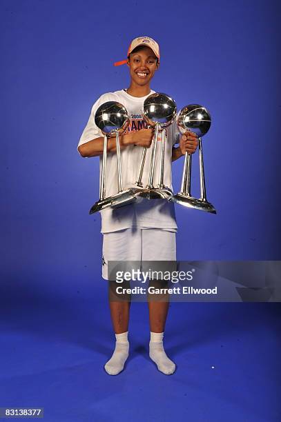 Deanna Nolan of the Detroit Shock poses for a portrait with the trophy after winning Game Three of the WNBA Finals against the San Antonio Silver...