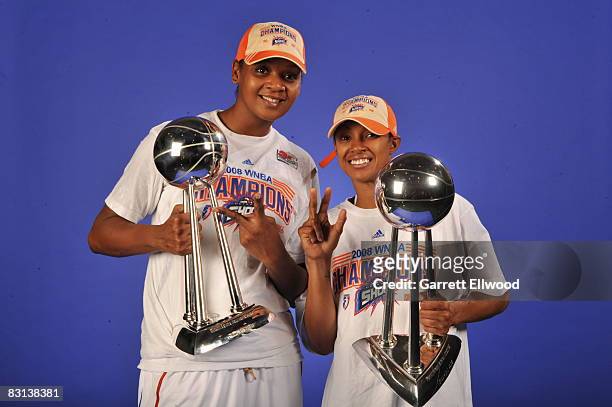 Kara Braxton and Deanna Nolan of the Detroit Shock poses for a portrait with the trophy after winning Game Three of the WNBA Finals against the San...