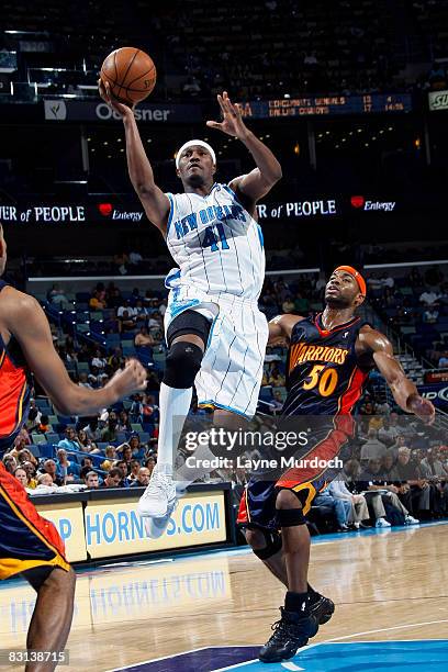 James Posey of the New Orleans Hornets shoots over Corey Maggette of the Golden State Warriors on October 5, 2008 at the New Orleans Arena in New...