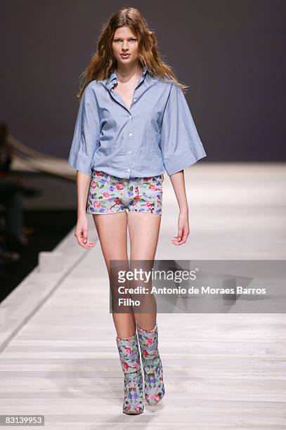 Model walks the runway at the Paul & Joe fashion show during Paris Fashion Week at Le Carrousel du Louvre on October 4, 2008 in Paris, France.