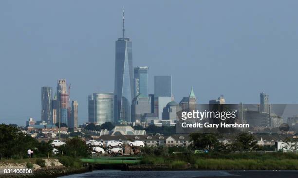 Traffic on the New Jersey Turnpike drives past the skyline of lower Manhattan and One World Trade Center in New York City on August 11, 2017 as seen...