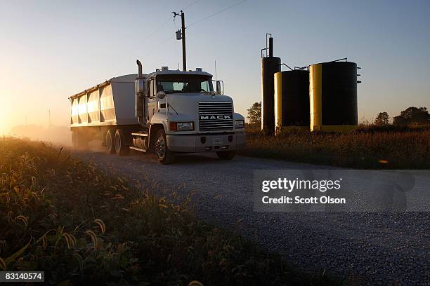 Grain truck hauling corn passes a crude oil storage battery on October 4, 2008 near New Haven, Illinois. Crude oil production in Illinois has been...