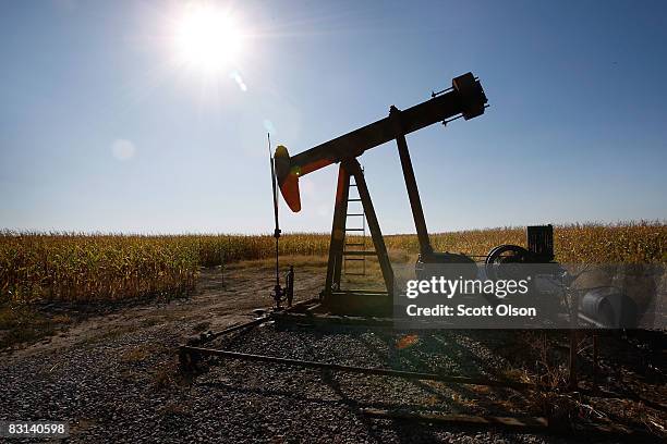 An oil well sits in the middle of a corn field on October 3, 2008 near Norris City, Illinois. Crude oil production in Illinois has been steadily...