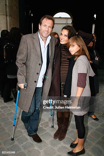 Stephane Freiss his wife Ursula and their daughter Camille leave the Louis Vuitton fashion show during Paris Fashion Week Spring/Summer '09 on...