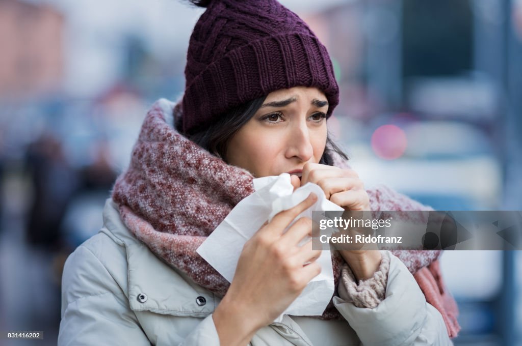 Woman coughing in winter