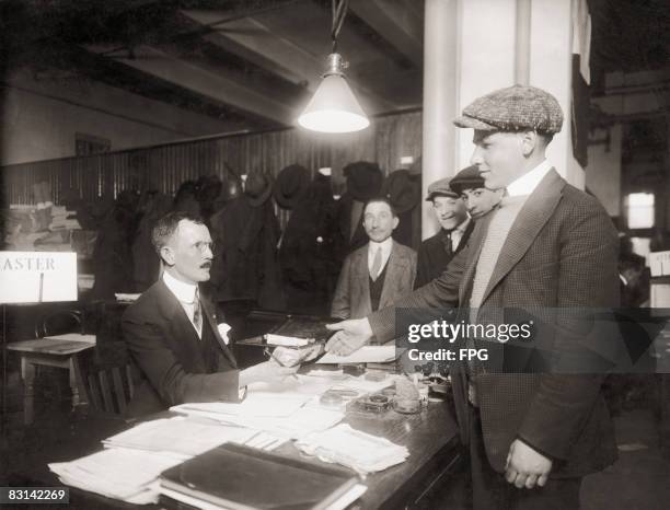 New recruit to the US Army draws his first pay, circa 1918.