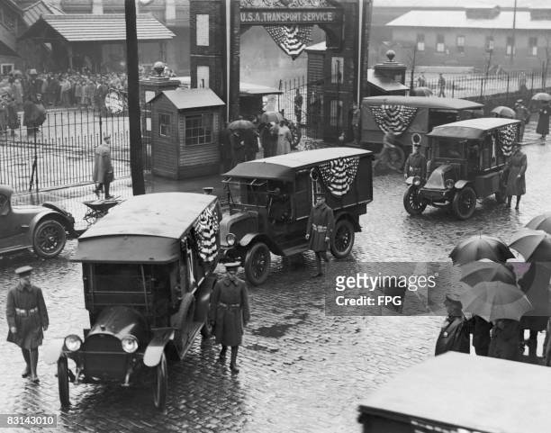 Military ambulances leaving pier 4 at Hoboken, New Jersey, with the repatriated bodies of American servicemen killed in Europe during World War I,...