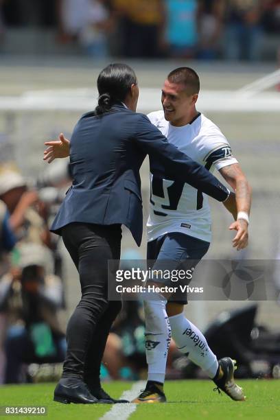 Nicolas Castillo of Pumas celebrates with his coach Juan Francisco Palencia after scoring the second goal of his team during the fourth round match...