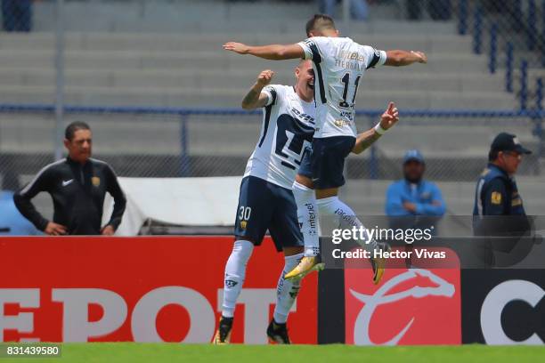 Nicolas Castillo of Pumas celebrates with teammate Bryan Rabello after scoring the second goal of his team during the fourth round match between...