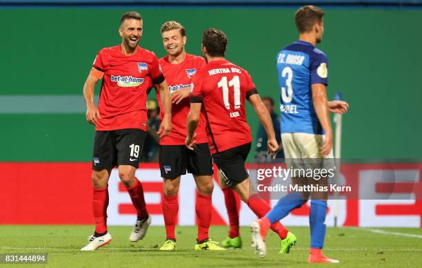 Vedad Ibisevic of Berlin celebrates with team mates after scoring the second goal during the DFB Cup first round match between FC Hansa Rostock and...