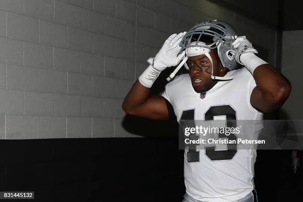 Running back John Crockett of the Oakland Raiders walks out onto the field before the NFL game against the Arizona Cardinals at the University of...