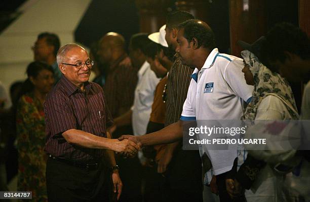 Maldives president and the Dhivehi Rahyithunge Party's presidential candidate Maumoon Abdul Gayoom greets supporters after his arrival from an...