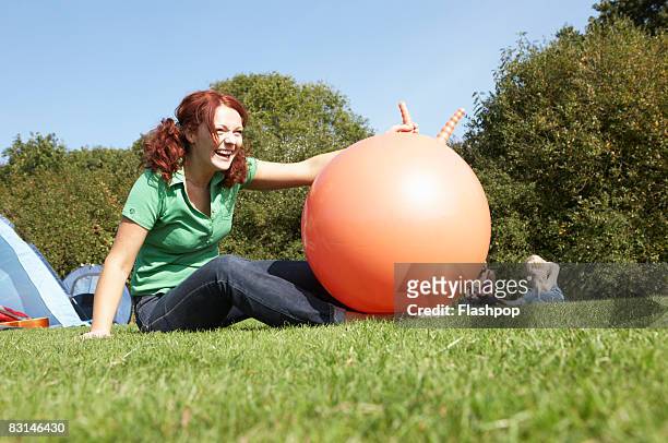 portrait of woman laughing - space hopper stock pictures, royalty-free photos & images