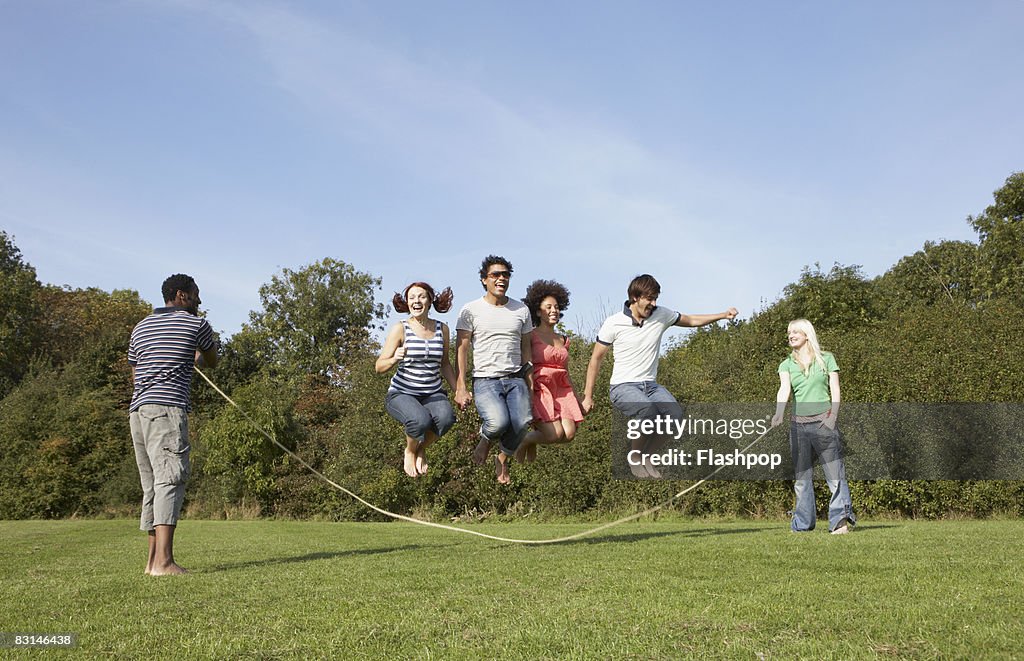 Group portrait of friends skipping