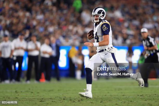Sean Mannion of the Los Angeles Rams runs with the ball during the first half of a preseason game against the Dallas Cowboys at Los Angeles Memorial...