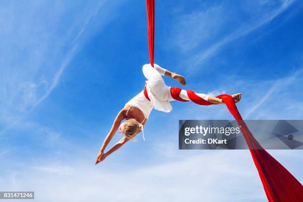 woman practicing aerial silk yoga outdoors - draped silk stock pictures, royalty-free photos & images