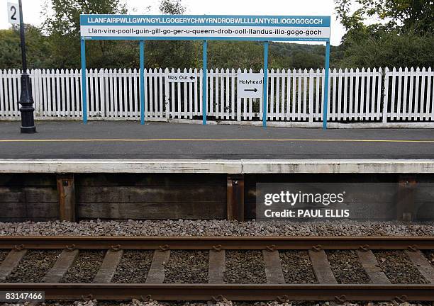 The town sign at Llanfairpwllgwyngyllgogerychwyrndrobwllllantysiliogogogoch railway station in Anglesey, Wales, is pictured on October 6, 2008. The...