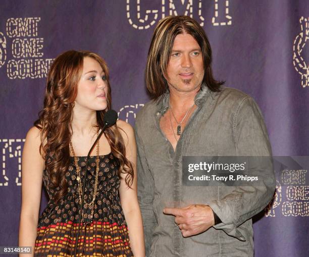 Singer/actress Miley Cyrus and singer/actor Billy Ray Cyrus interview in the press room during the 2008 CMT Music Awards at Curb Event Center at...