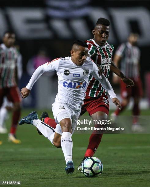 Vladimir Hernandez of Santos battles for the ball with Leo of Fluminense during the match between Santos and Fluminense as a part of Campeonato...