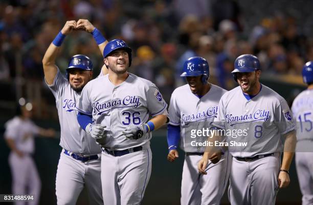 Cam Gallagher of the Kansas City Royals is congratulated by Melky Cabrera, Alcides Escobar and Mike Moustakas after he hit a grand slam home run in...
