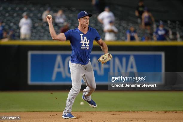 Chase Utley of the Los Angeles Dodgers fields ground balls during batting practice before the MLB game against the Arizona Diamondbacks at Chase...