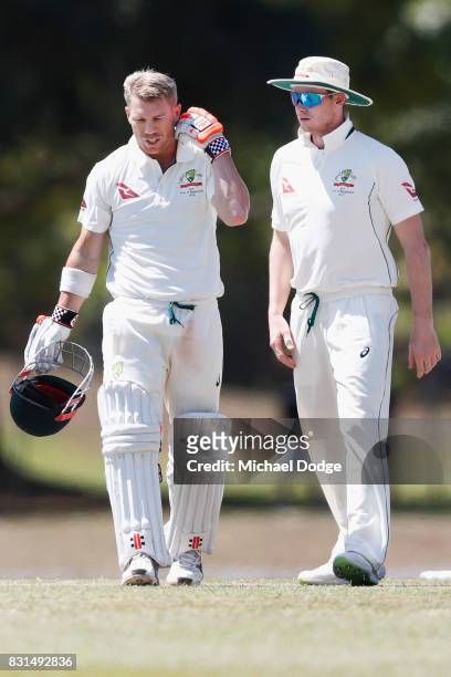 David Warner is attended to by Steve Smith after being hit by a Josh Hazelwood bouncer during day two of the Australian Test cricket inter-squad...