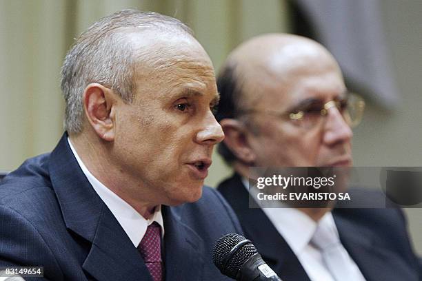 Brazil's Finance Minister Guido Mantega speaks nexst to Brazil's Central Bank President Henrique Meirelles during a press conference on October 6 in...