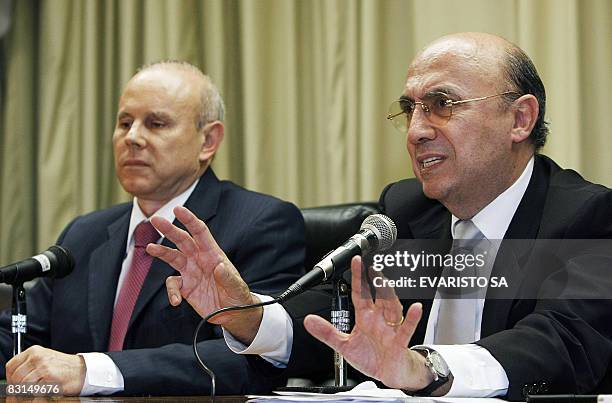 Brazil's Central Bank President Henrique Meirelles speaks next to Brazil's Finance Minister Guido Mantega during a press conference on October 6 in...