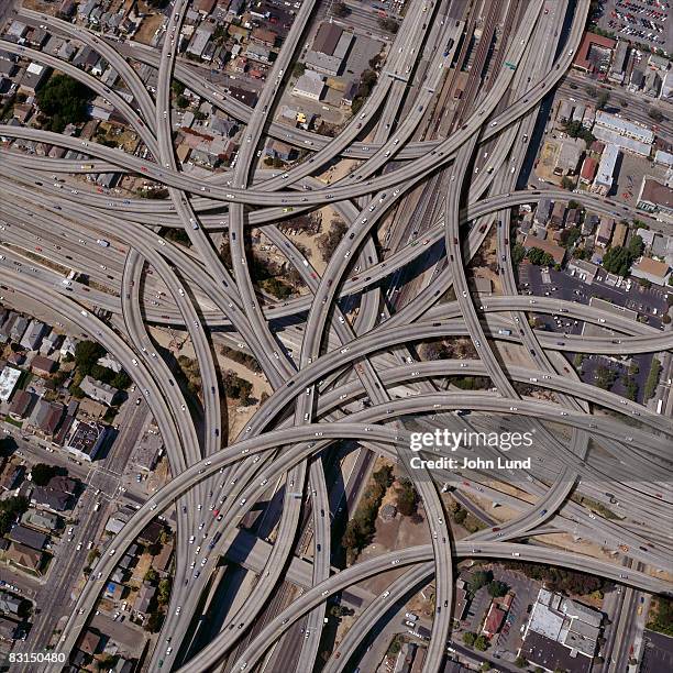 exaggerated complex freeway interchanges - complex fotografías e imágenes de stock