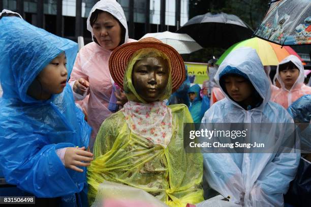 South Korea children look at a comfort woman statue during a 72nd Liberation Day rally in front of Japanese embassy on August 15, 2017 in Seoul,...