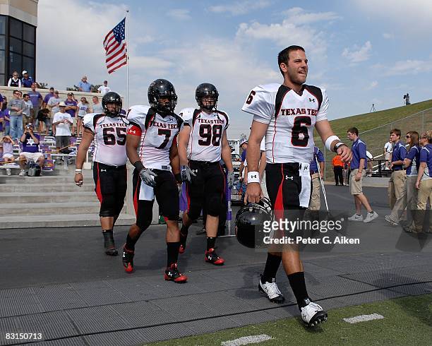 Quarterback Graham Harrell of the Texas Tech Red Raiders leads team captains Darcel McBath Jake Ratliff and Louis Vasquez onto the field before a...