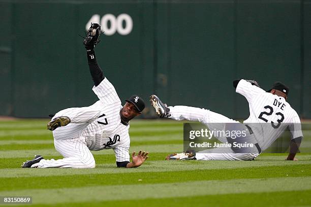 Ken Griffey Jr. #17 of the Chicago White Sox makes a diving catch, in front of teammate Jermaine Dye, for the third out in the top of the fourth...